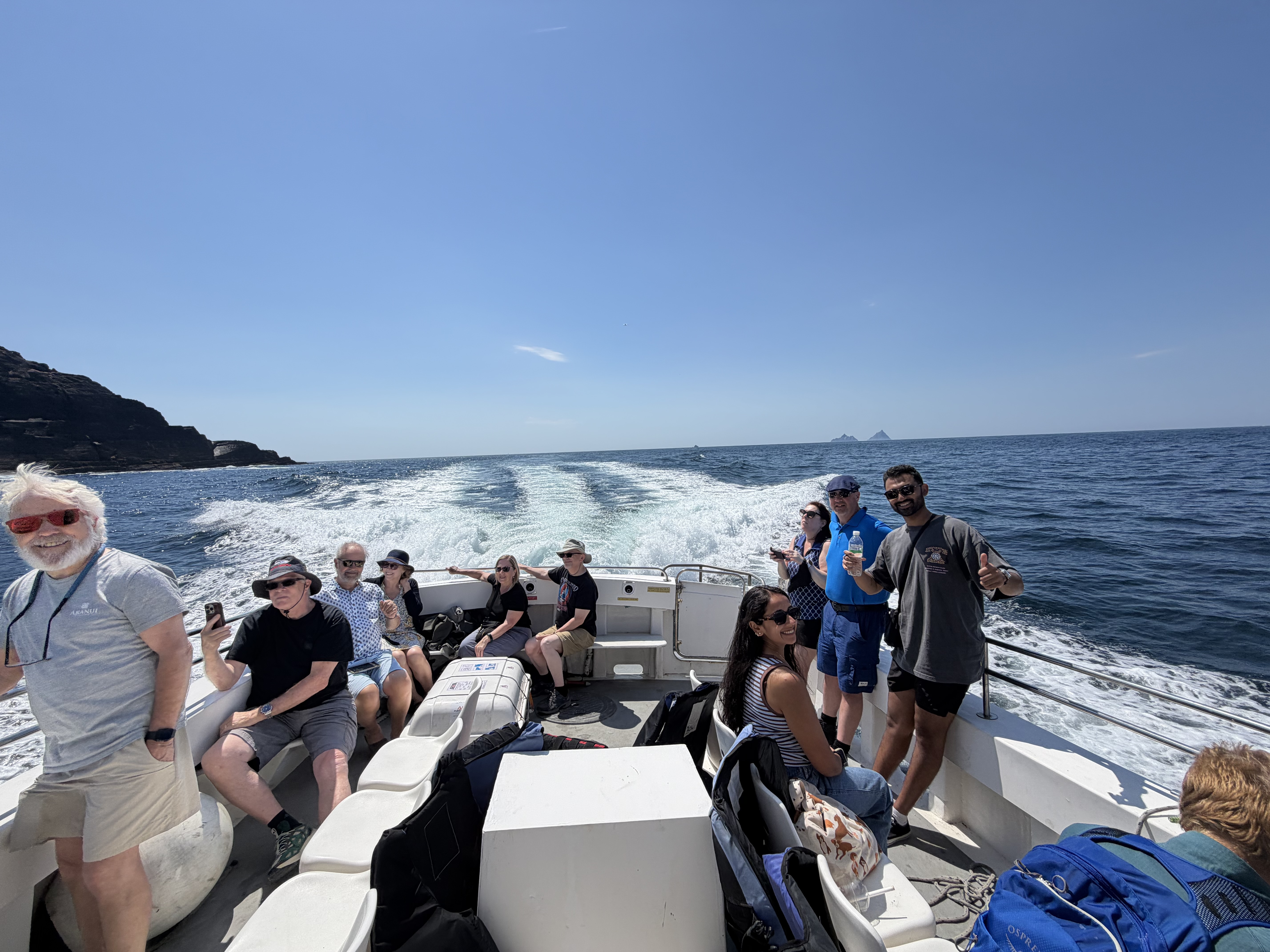 Happy guests aboard the Skellig Coastal Cruise with Skellig Michael on the horizon